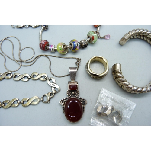 1087 - Silver jewellery including four bracelets/bangles, a pendant and chain and a silver spinner ring