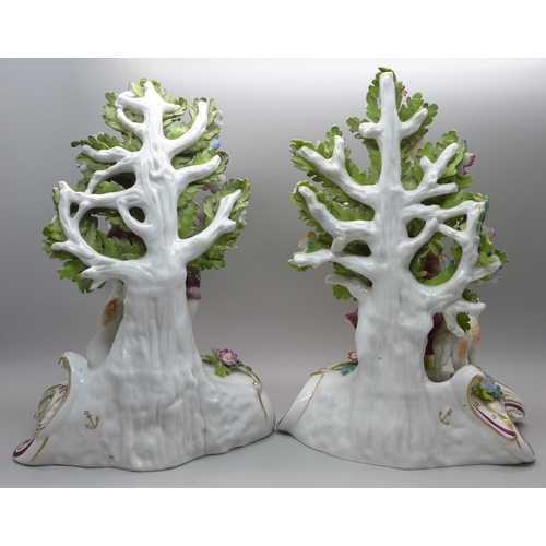 618 - A pair of porcelain bocage detail figures with gold anchor marks, 22cm, lady restored
