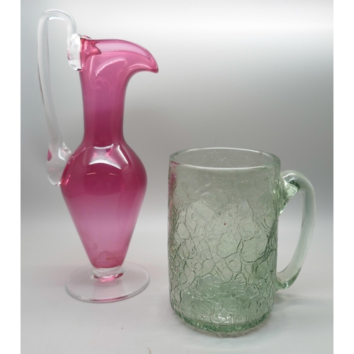 657 - A cranberry glass ewer/vase and a crackle glass mug