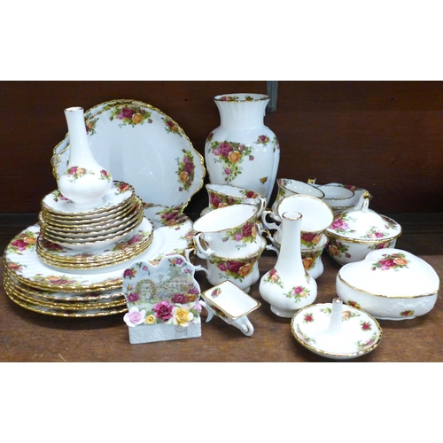 676 - Royal Albert Old Country Roses; six dinner plates, two bread and butter plates, a vase and two posy ... 