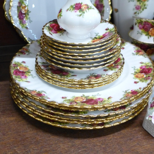 676 - Royal Albert Old Country Roses; six dinner plates, two bread and butter plates, a vase and two posy ... 