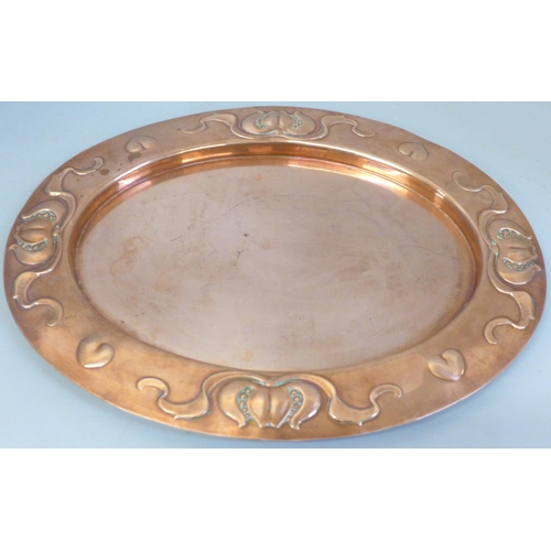 679 - An Arts and Crafts oval copper platter, 36cm wide