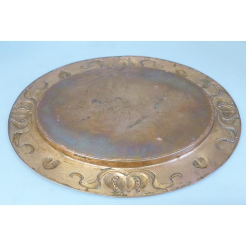 679 - An Arts and Crafts oval copper platter, 36cm wide