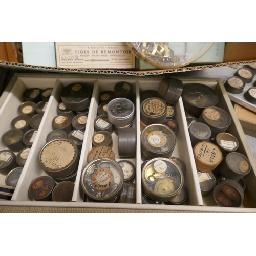 701 - Two boxes of watch materials including main springs, crowns, rotor wheels, etc. **PLEASE NOTE THIS L... 