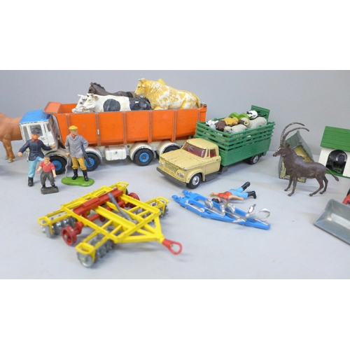 713 - A collection of farmyard models and vehicles, animals, etc.