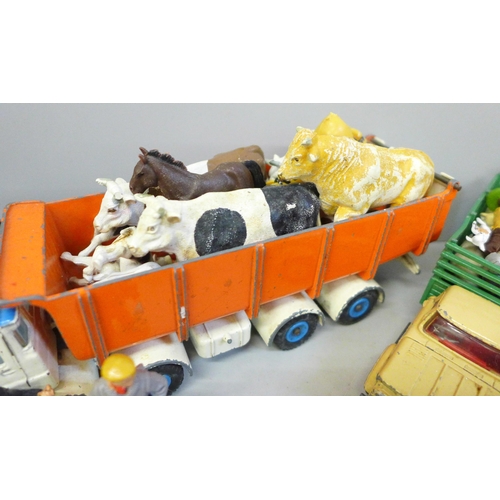 713 - A collection of farmyard models and vehicles, animals, etc.