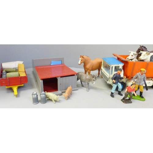 713 - A collection of farmyard models and vehicles, animals, etc.