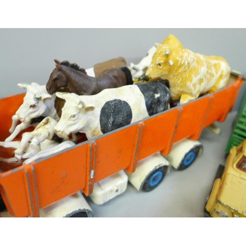 713 - A collection of farmyard models and vehicles, animals, etc.