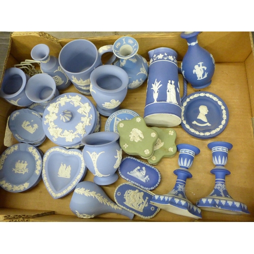 740 - A box of Wedgwood Jasperware including a pair of dark blue candlesticks, jug and vase