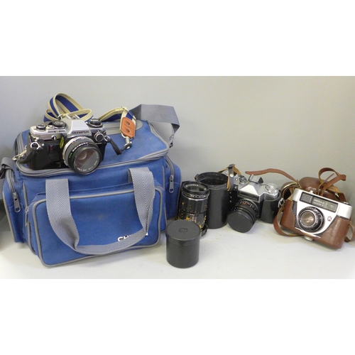 758 - An Olympus OM10 camera with accessories and camera bag, a Peacemaker camera, a Zenit camera and two ... 