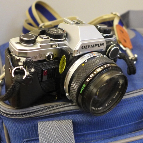 758 - An Olympus OM10 camera with accessories and camera bag, a Peacemaker camera, a Zenit camera and two ... 