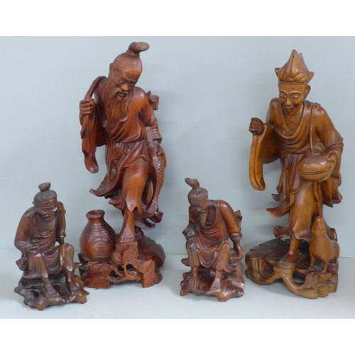 819 - Two pairs of Chinese hardwood carved figures, tallest 31cm, one lacking staff