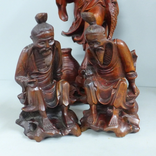 819 - Two pairs of Chinese hardwood carved figures, tallest 31cm, one lacking staff