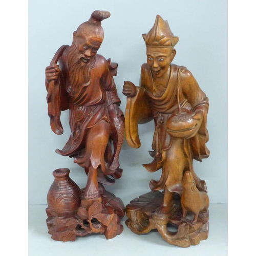 819 - Two pairs of Chinese hardwood carved figures, tallest 31cm, one lacking staff