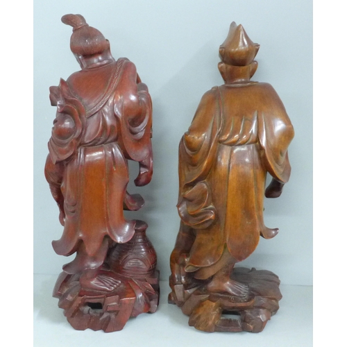 819 - Two pairs of Chinese hardwood carved figures, tallest 31cm, one lacking staff