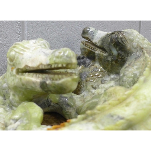 827 - A large carved Chinese jade model of two entwined crocodiles, tail and back claw a/f, 66cm, 35kg **P... 