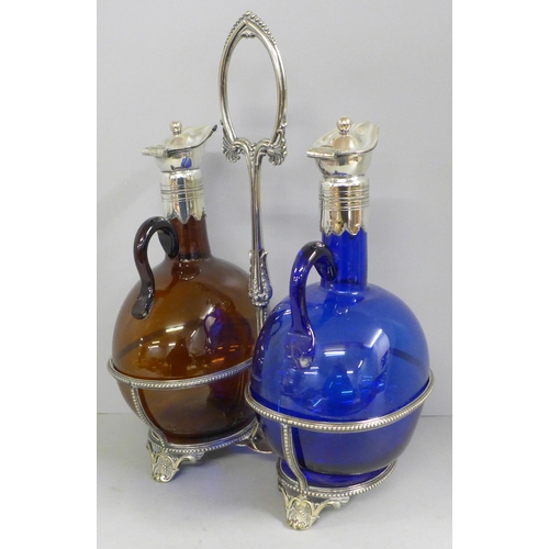 828 - A pair of oil bottles with plated tops, blue and brown glass, on a plated stand