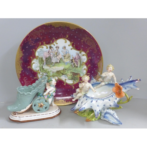 829 - A continental wall plaque, a posy vase with cherubs and a German porcelain cherub shoe posy holder w... 