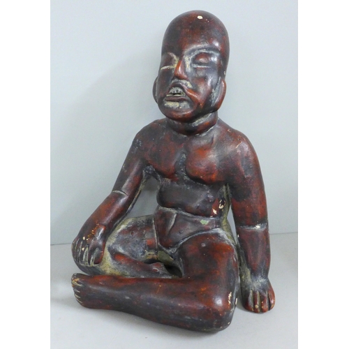 831 - A terracotta figure of a native, seated, 19cm