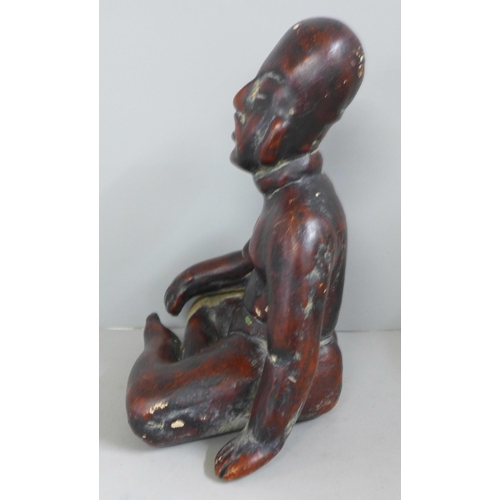 831 - A terracotta figure of a native, seated, 19cm