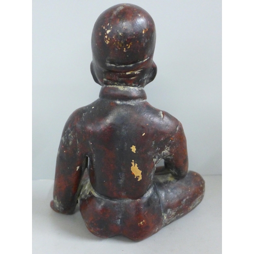 831 - A terracotta figure of a native, seated, 19cm