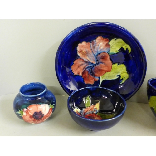 832 - Five items of early 20th Century Moorcroft china, two vases, two bowls and a dish; Hibiscus, Orchid ... 