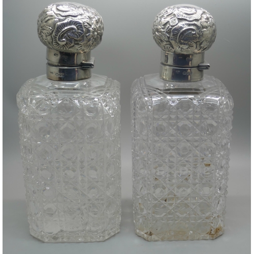 862 - A pair of Victorian silver topped glass decanters, with hinged tops and inner stoppers, London 1890,... 