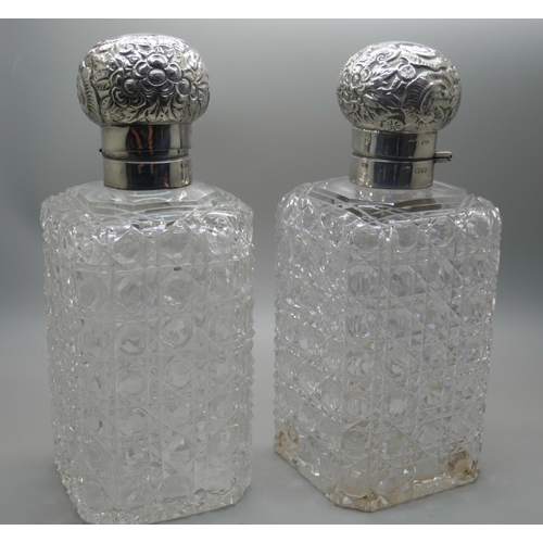 862 - A pair of Victorian silver topped glass decanters, with hinged tops and inner stoppers, London 1890,... 