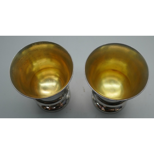 864 - A pair of small American silver goblets with gilt interiors, 137g, marked International Sterling