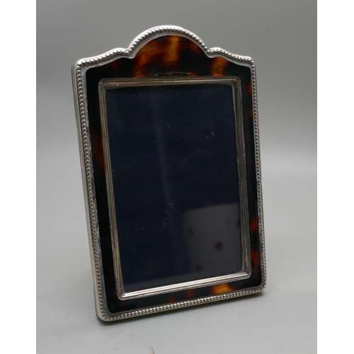 865 - A silver photograph frame, height 12cm, faux tortoiseshell