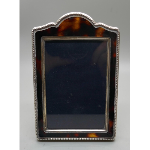 865 - A silver photograph frame, height 12cm, faux tortoiseshell