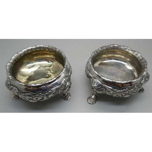 874 - A pair of Georgian silver salt cellars, worn London mark, underside bears crest, 344g