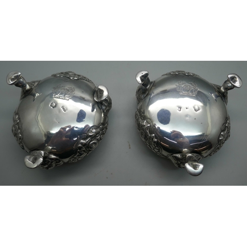 874 - A pair of Georgian silver salt cellars, worn London mark, underside bears crest, 344g