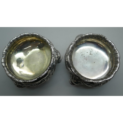 874 - A pair of Georgian silver salt cellars, worn London mark, underside bears crest, 344g