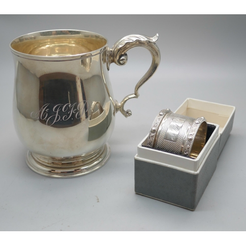 881 - A silver mug, Birmingham 1970, 226g, and a boxed silver napkin ring with dragon detail, 39g