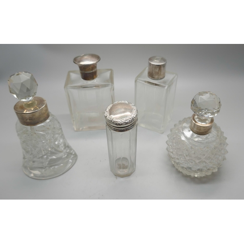 885 - Five silver topped/mounted dressing table bottles, one with continental marked, one top dented