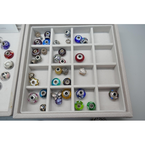 888 - A collection of twenty-one Pandora charms, twenty-nine other charms, some marked LAA, a Pandora brac... 