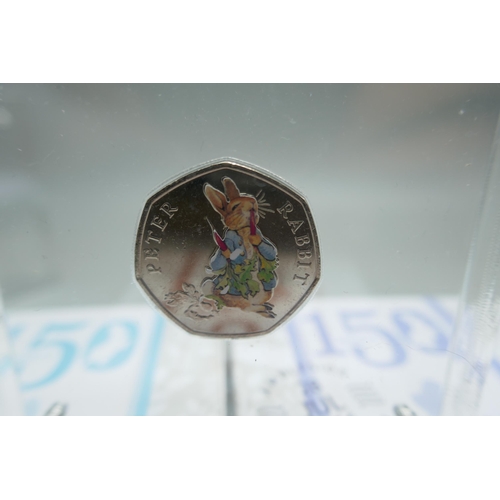 895 - Eleven cased Royal Mint Beatrix Potter 150 years 50p coins; presented in Perspex blocks .