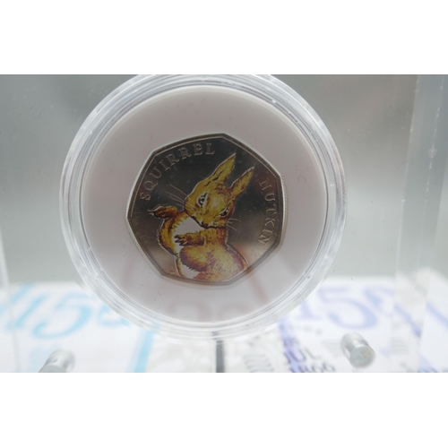 895 - Eleven cased Royal Mint Beatrix Potter 150 years 50p coins; presented in Perspex blocks .