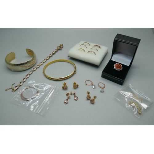 908 - A collection of silver and silver gilt jewellery including two bangles, rings, earrings, etc.