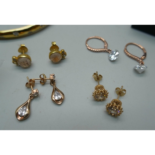 908 - A collection of silver and silver gilt jewellery including two bangles, rings, earrings, etc.