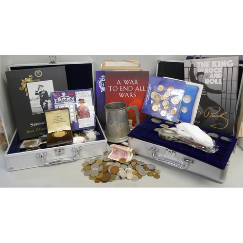 932 - A collection of coins in two aluminium cases; uncirculated coin sets, commemorative coins in cases a... 