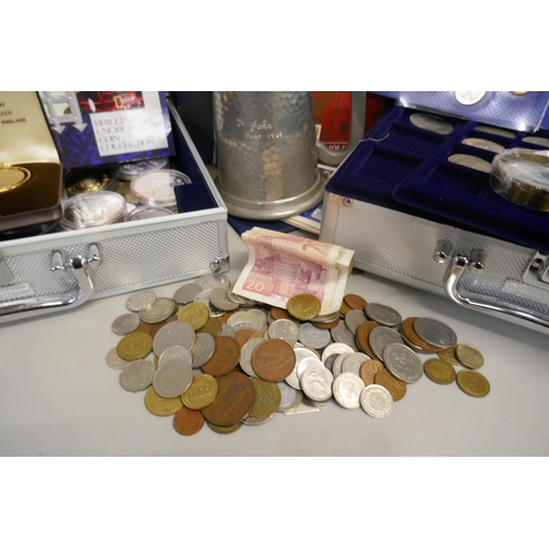 932 - A collection of coins in two aluminium cases; uncirculated coin sets, commemorative coins in cases a... 