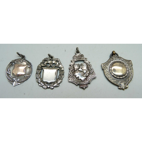 942 - Three silver fob medals including one with gold applied plaque, 21g, and one other fob medal