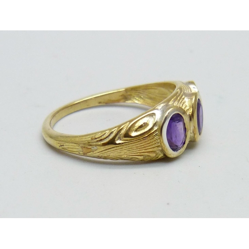 947 - A silver gilt, amethyst three stone ring, T/U