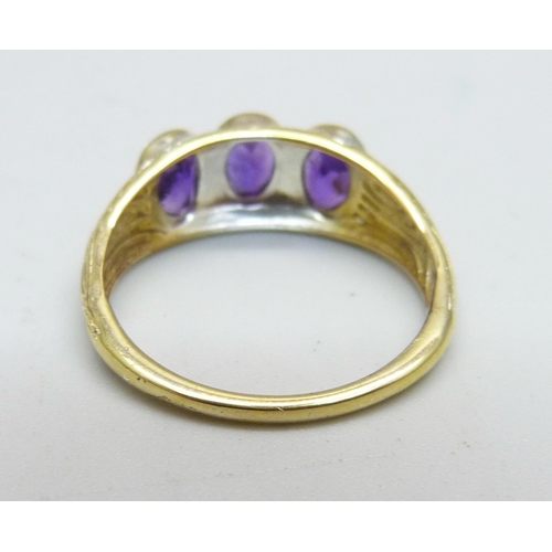 947 - A silver gilt, amethyst three stone ring, T/U