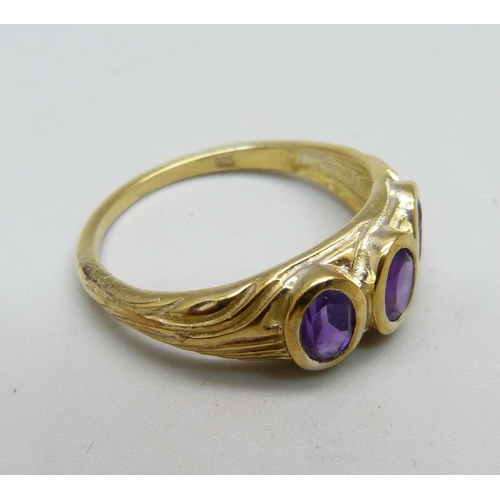 947 - A silver gilt, amethyst three stone ring, T/U