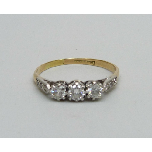 970 - An 18ct gold ring set with nine diamonds, 2.2g, T