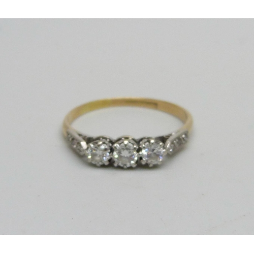 970 - An 18ct gold ring set with nine diamonds, 2.2g, T