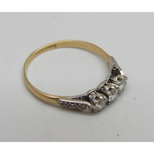 970 - An 18ct gold ring set with nine diamonds, 2.2g, T